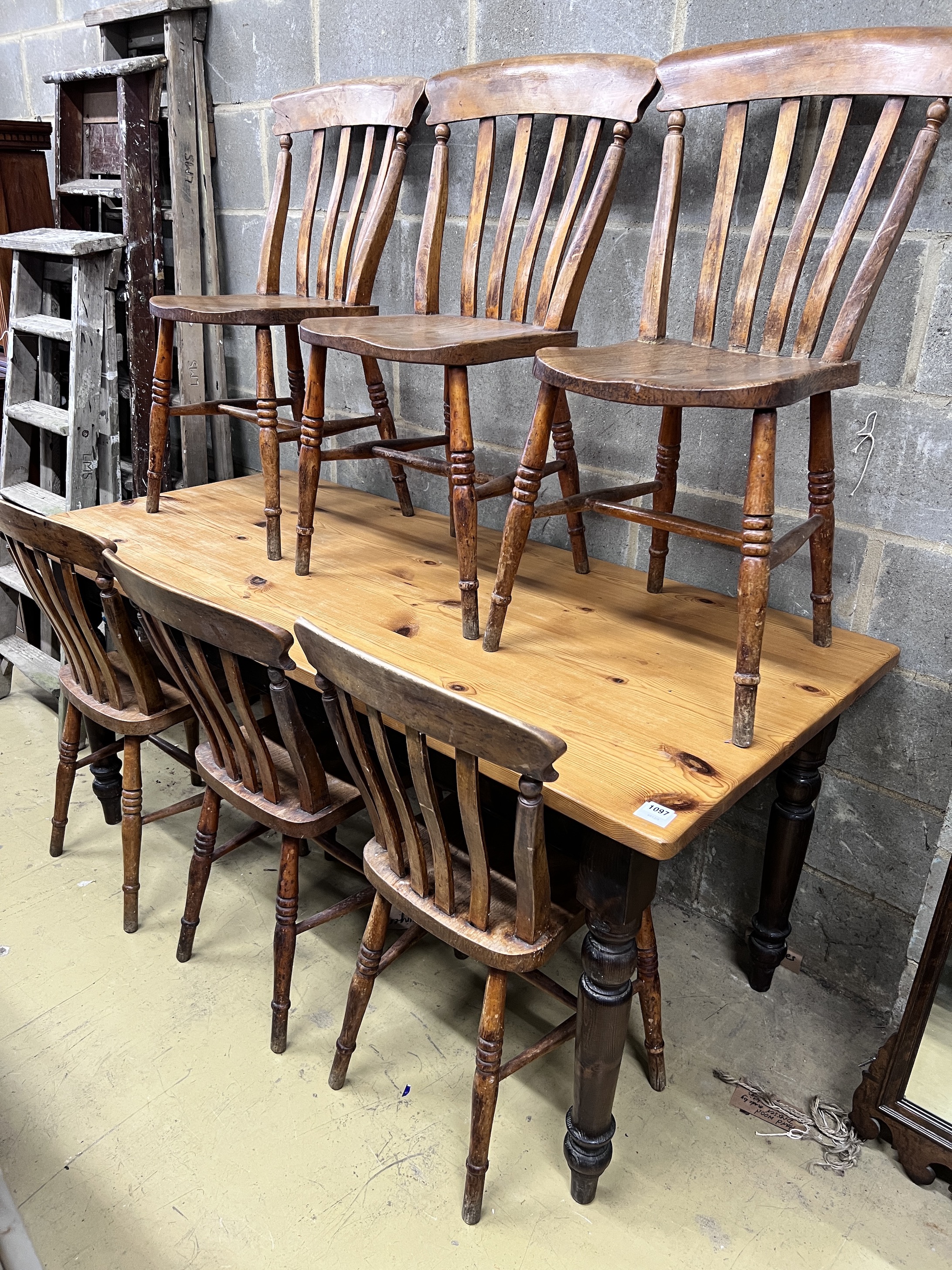 A Victorian style pine kitchen table with ebonised underframe, length 163cm, height 76cm and a set of six early 20th century lathe back kitchen chairs